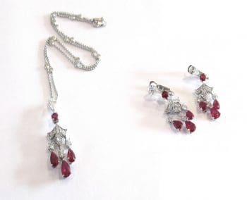 Graff. A ruby and diamond Lotus pendant and earrings