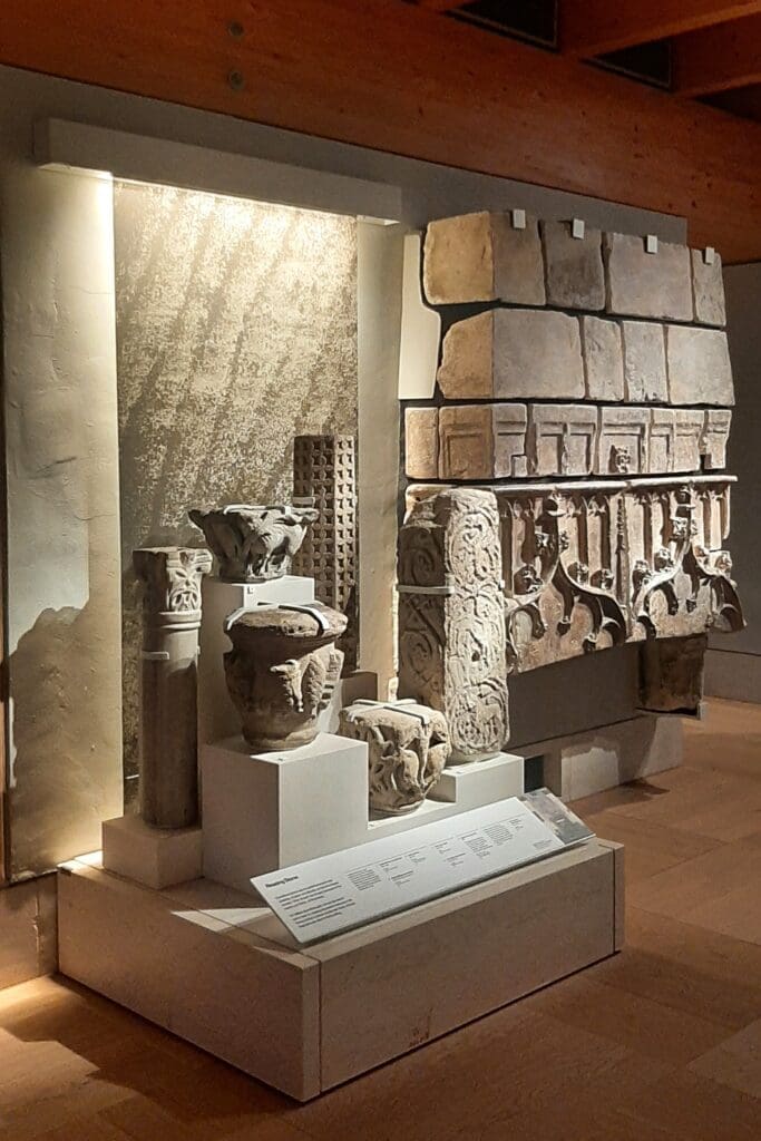 Various examples of mid-12th century stonework, including an Italian marble column, a French stone column and an English limestone capital.