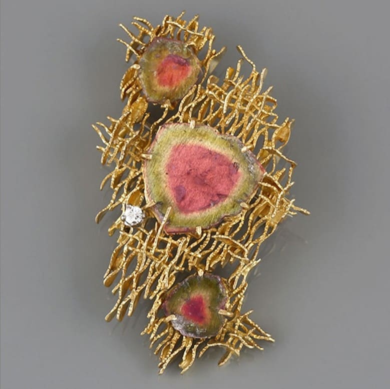 An 18ct gold tourmaline and diamond brooch by Alan Gard, 1967. We would look to insure this piece with a provisional valuation of £10,000, subject to change upon physical inspection of the piece.