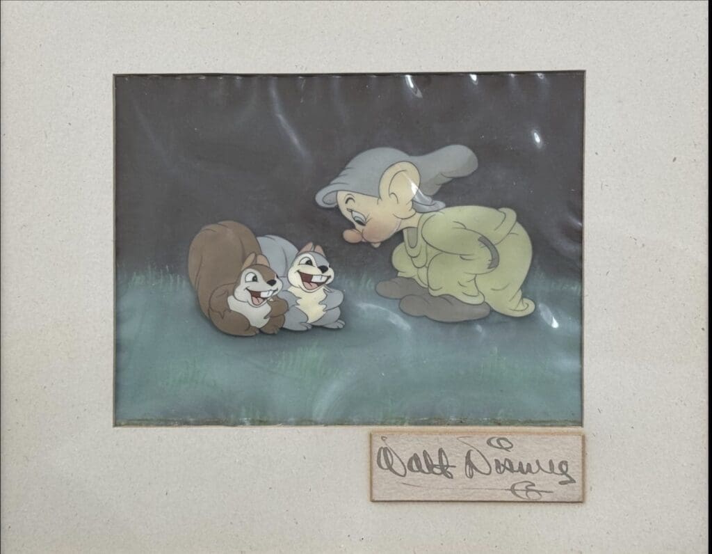 An original production cel from Snow White, the Original 1937 animated movie, featuring Dopey and signed on the mount by Walt Disney